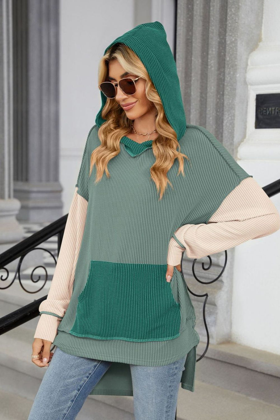 Green hooded sweater with contrast sleeves and pocket