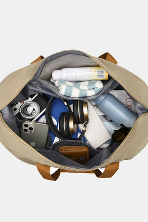 Loomirke Weekend Holdall duffel bag in tan, packed with essentials like headphones, phone, and toiletries.