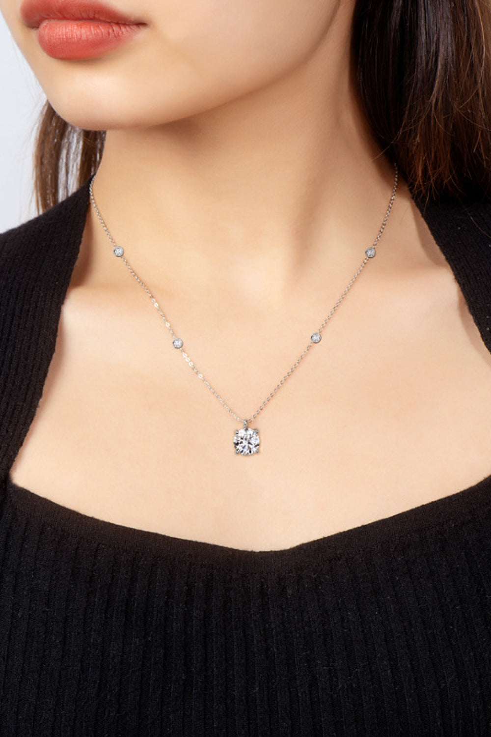 Silver floating moissanite solitaire necklace with scattered accent stones.