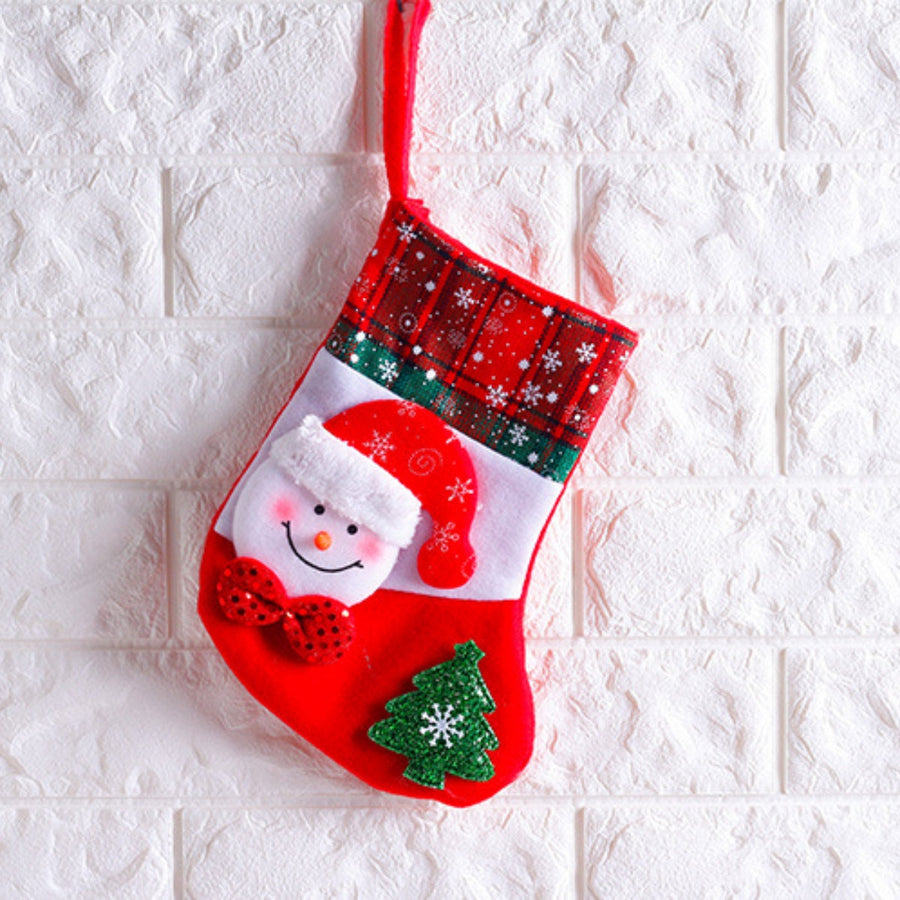 Festive Santa face Christmas stocking with plaid cuff, green trim, and appliqued tree.
