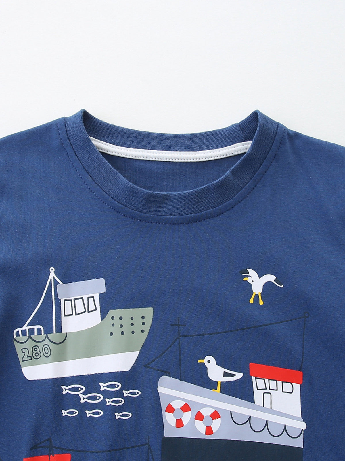 Toddler blue cotton t-shirt with crew neck and a nautical print of boats, fish, and seagulls.