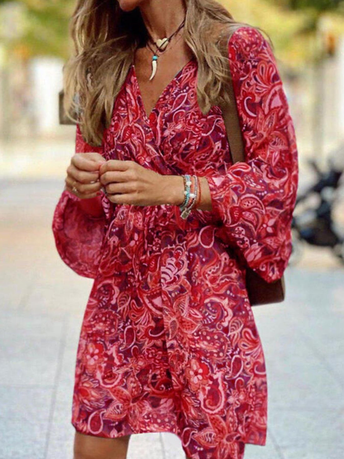 Red paisley print wrap dress with balloon sleeves and a V-neck.