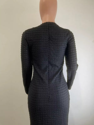Black textured midi dress with crew neck and decorative buttons, body-hugging cut.