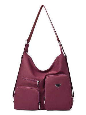 Burgundy nylon shoulder bag with multiple exterior pockets and silver hardware.