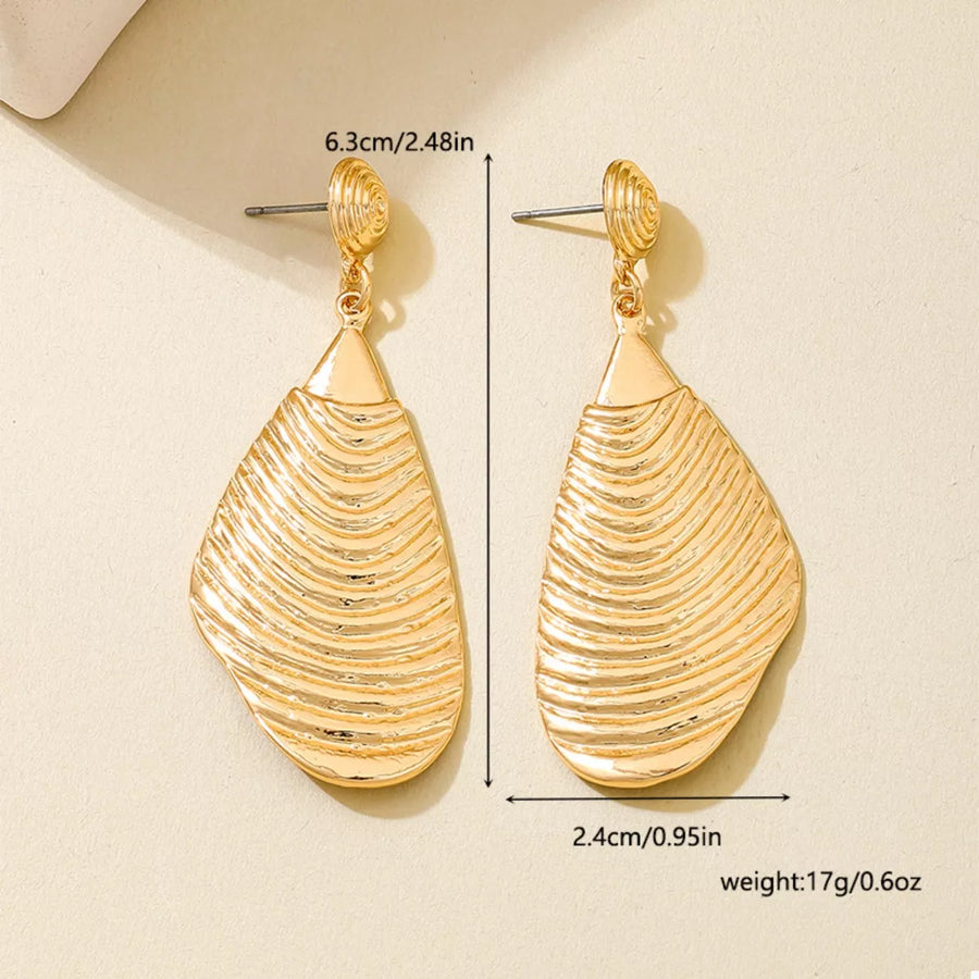 Textured gold dangle earrings with a wavy, shell-like design.