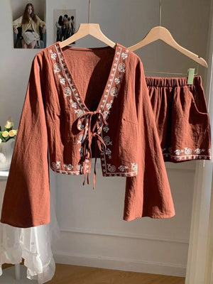 Brown embroidered tie-front top with bell sleeves and matching shorts set.