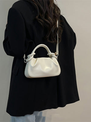 Off-white ruched crossbody bag with knot handle and adjustable strap