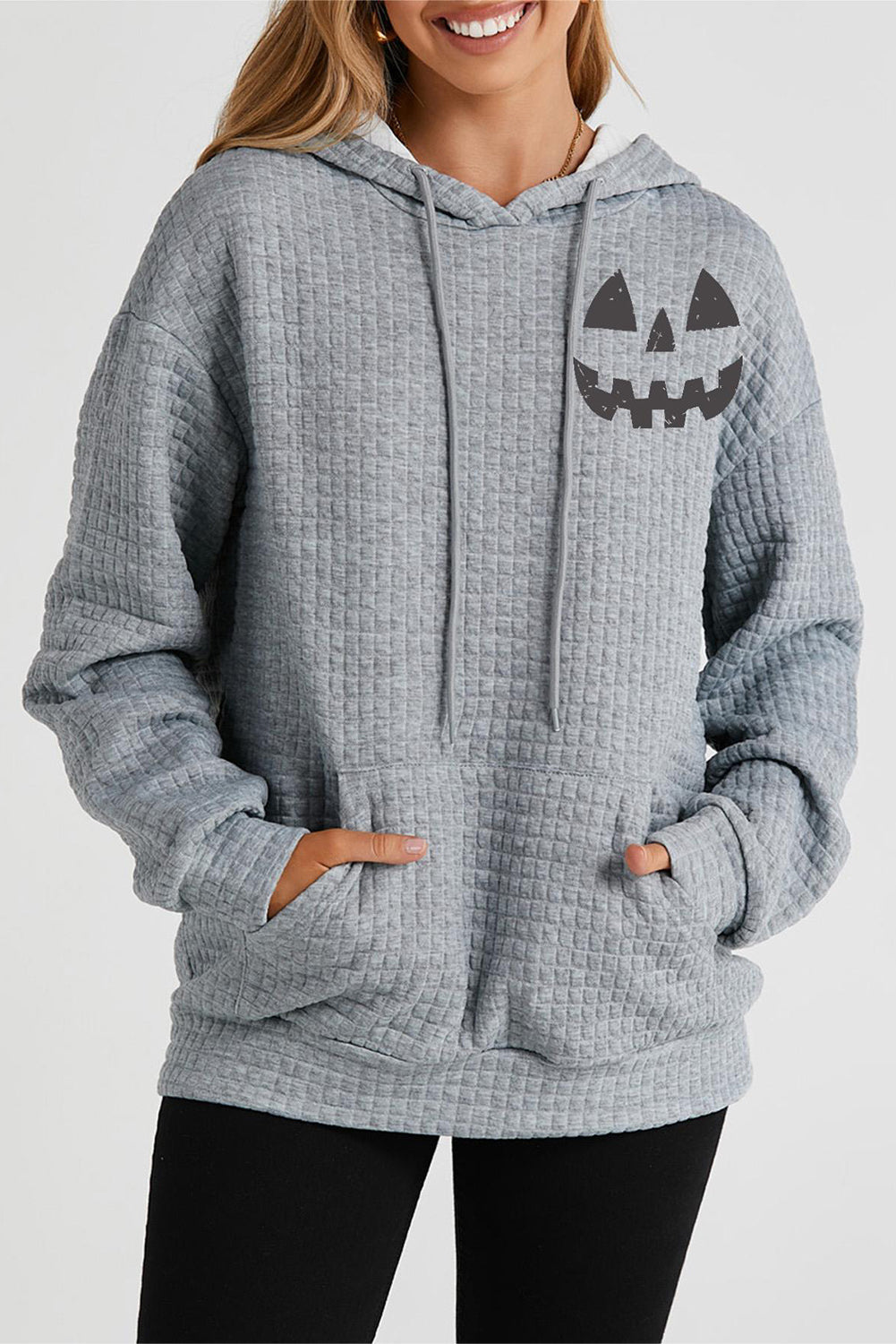 Charcoal waffle knit hoodie with jack-o-lantern graphic and front pocket.