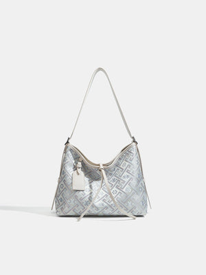 handbag in silver featuring adjustable strap and slouchy fit