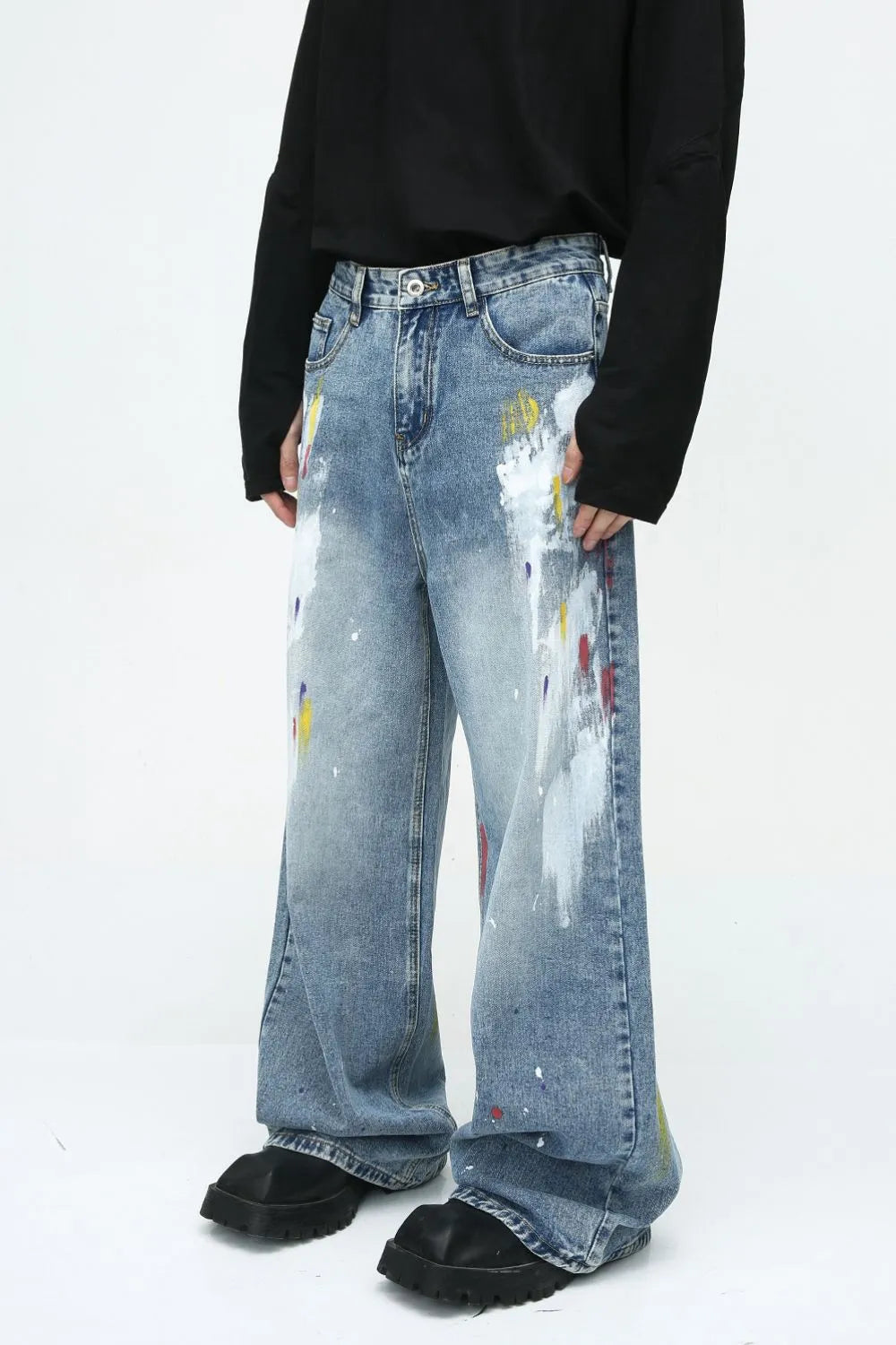 Painterly wash wide-leg denim trousers in medium blue with artistic paint splatters and wide leg.