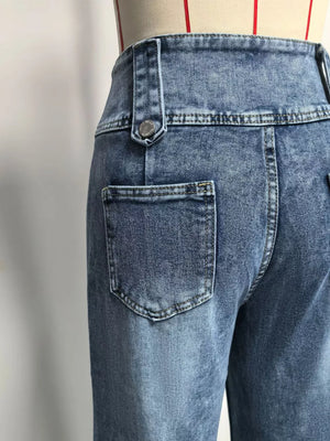 Wide-leg denim jeans in blue with button accents and a high waist.