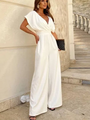 White surplice wide-leg romper with draped sleeves and a cinched waist.