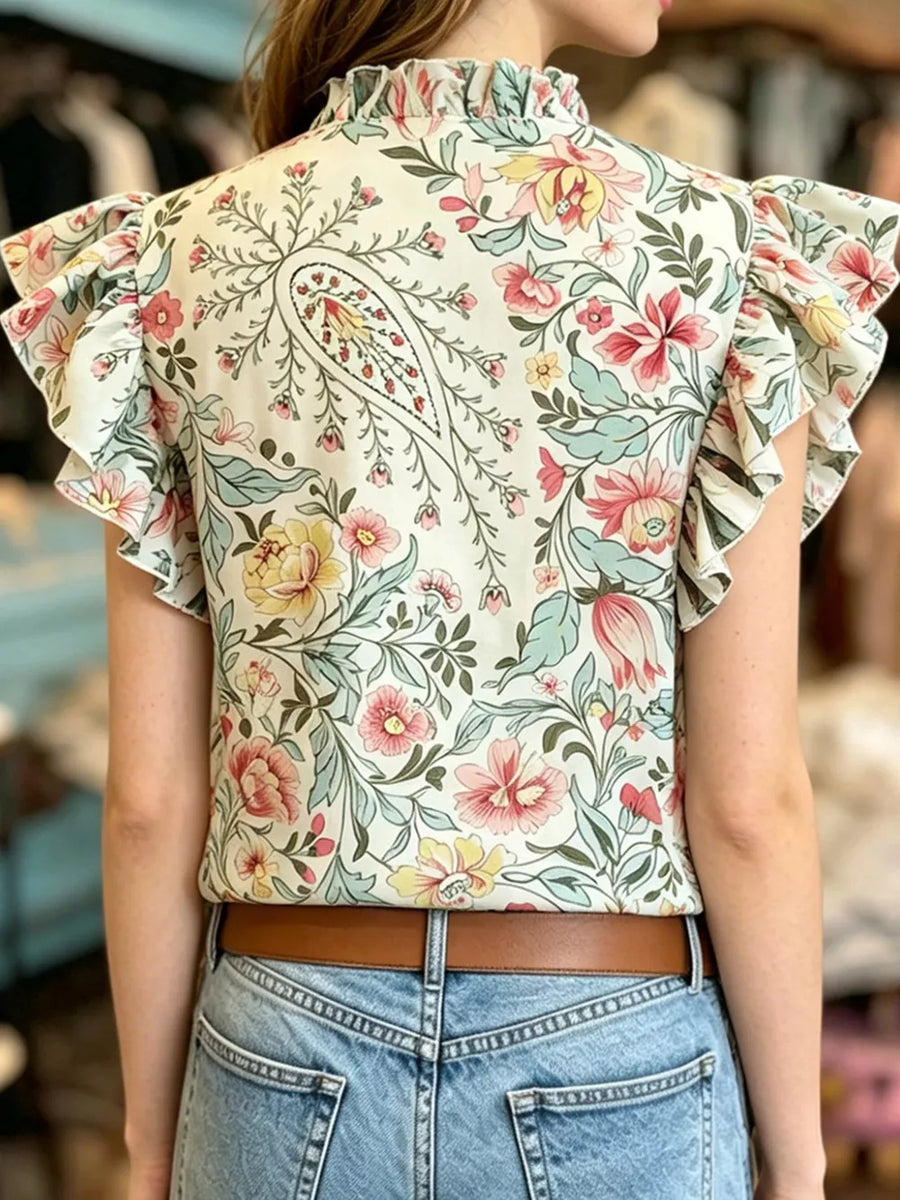 Cream floral print t-shirt with ruffled mock neck and flutter sleeves.