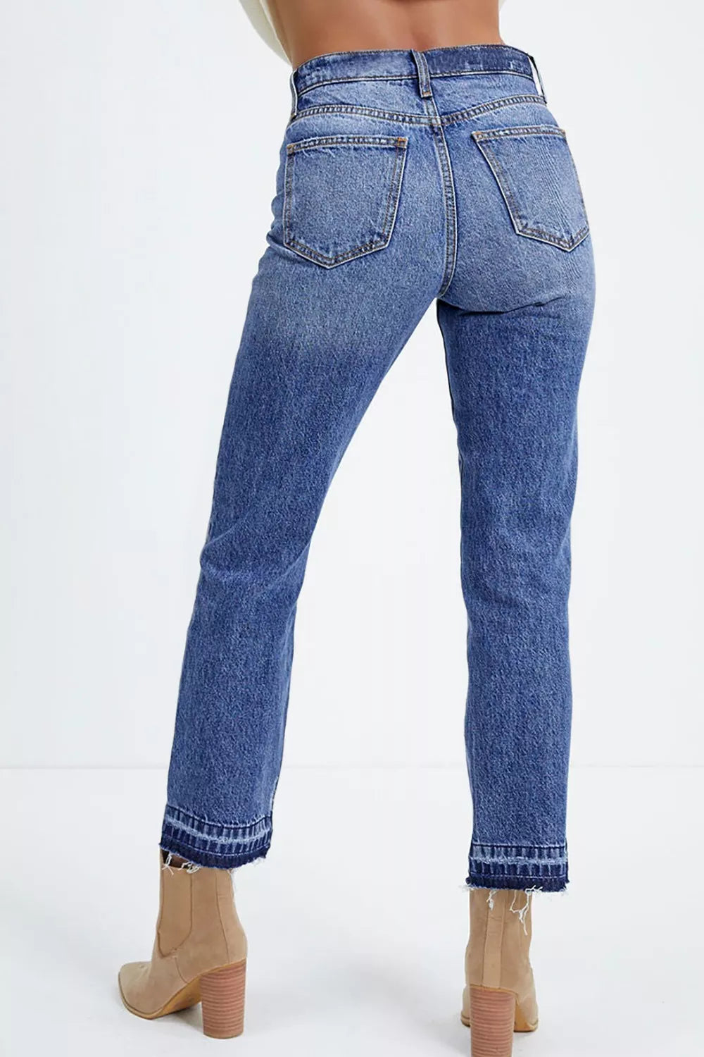 Women's blue cropped jeans with raw hem detail and a slight fade.