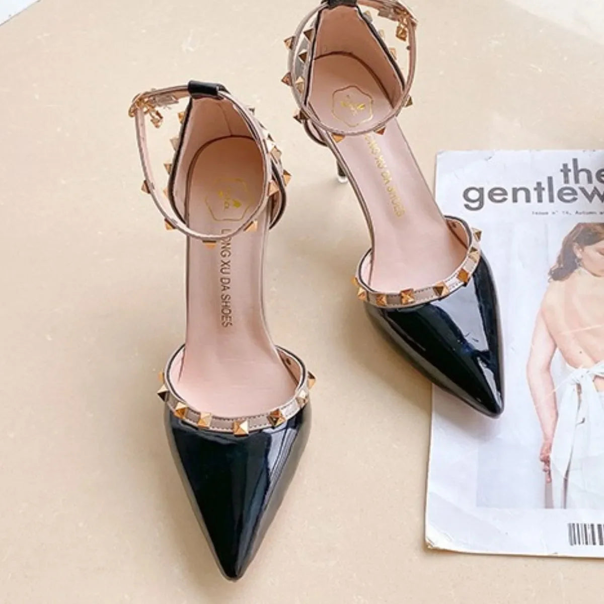 Black patent ankle strap pumps with gold studs