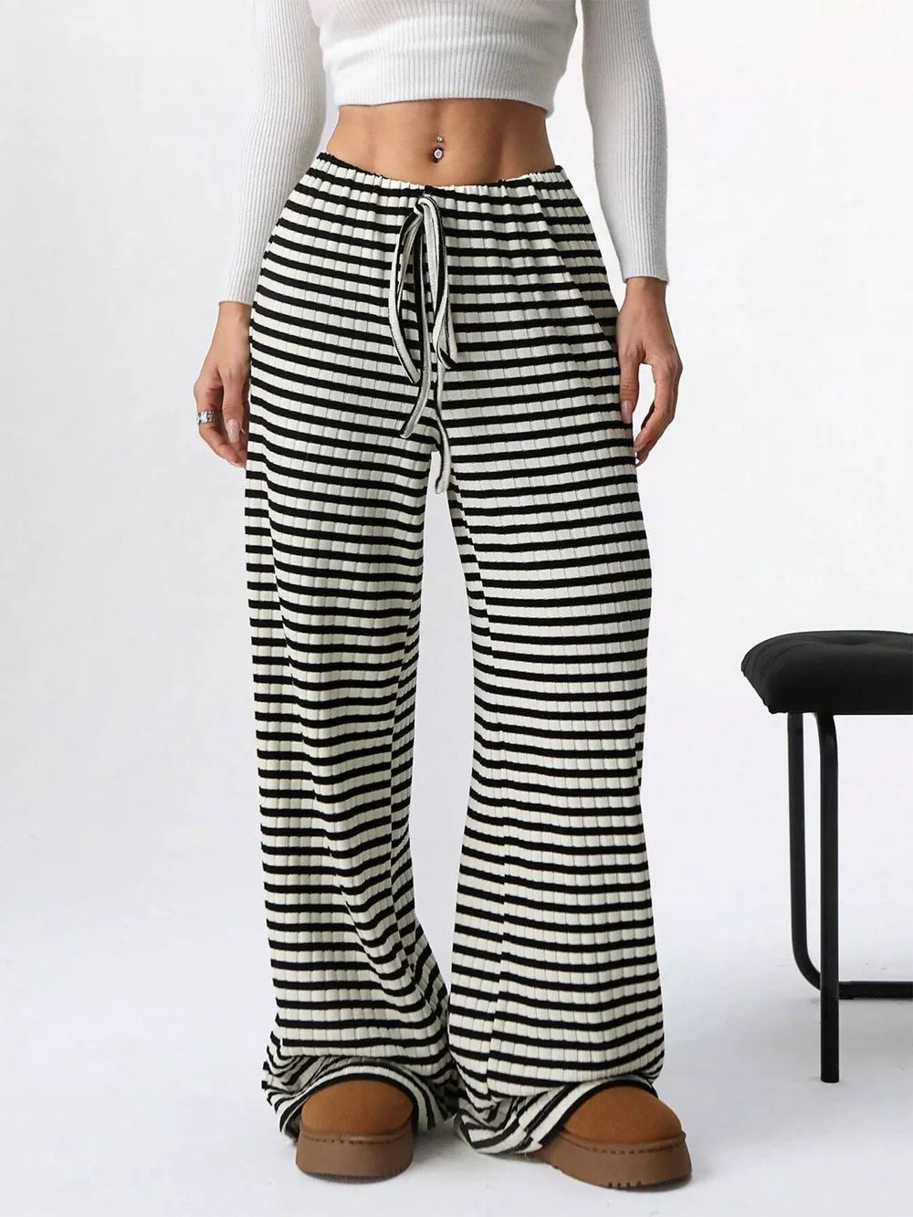Striped ribbed wide-leg pants with drawstring waist in black and white.