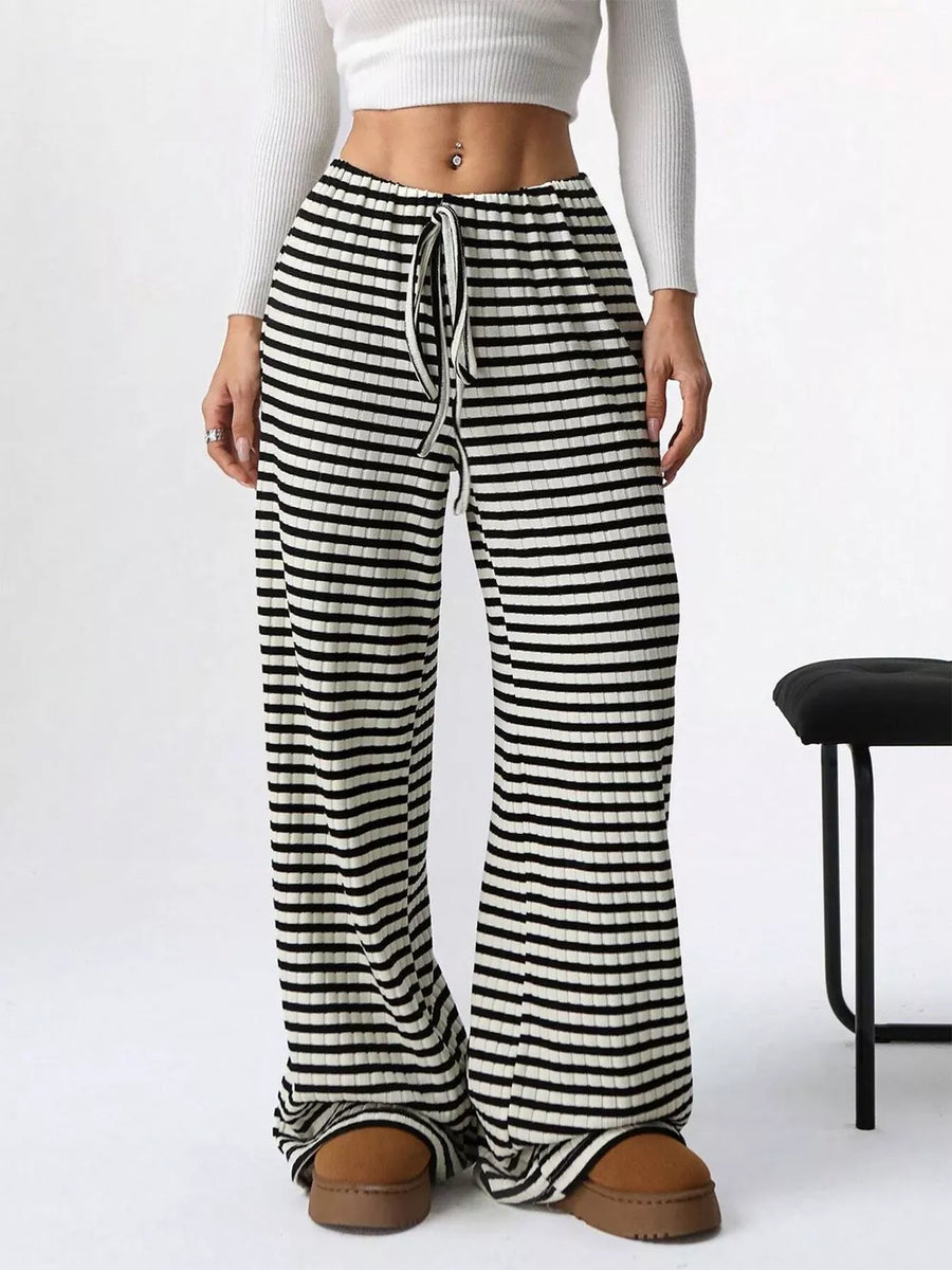 Striped ribbed wide-leg pants with drawstring waist in black and white.