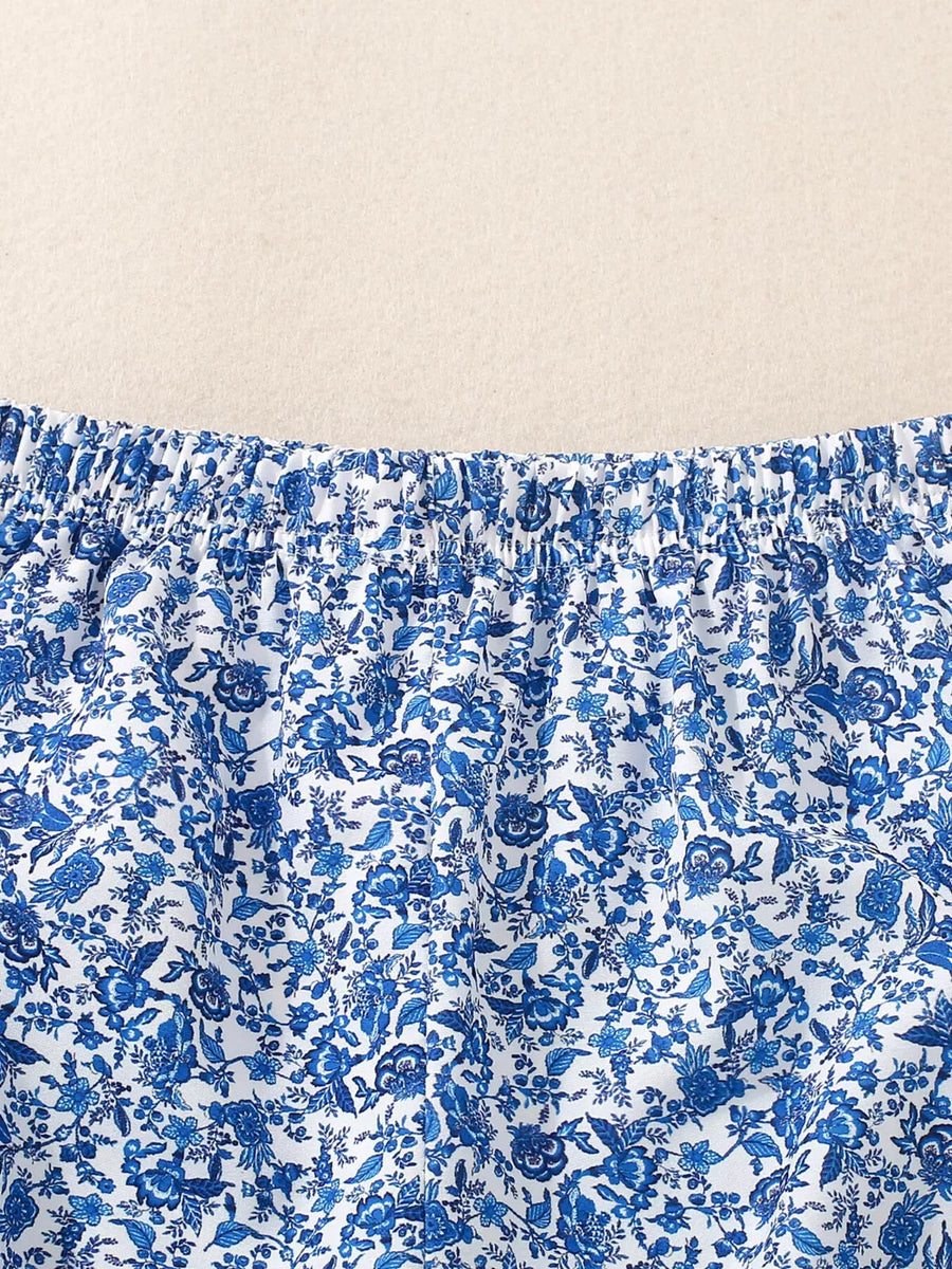 Baby blue floral print cotton set with smocked waist detail.