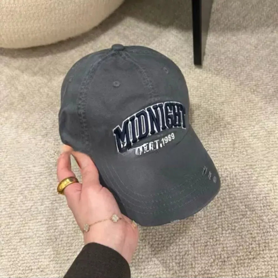Grey distressed baseball cap with "MIDNIGHT EST. 1989" embroidery