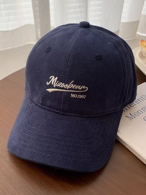 Navy blue cotton baseball cap with embroidered white lettering and curved brim.