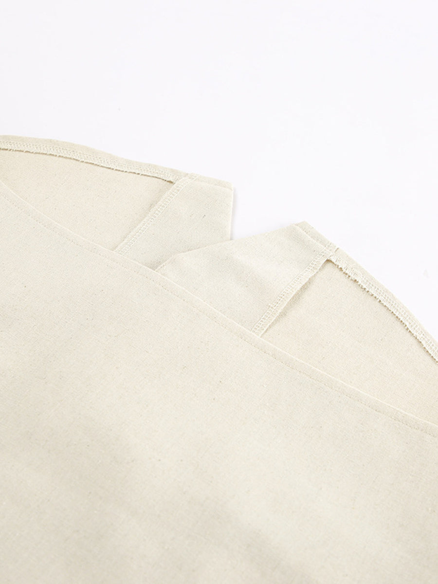 Buttoned vest and shorts set in natural cotton fabric with visible stitching details.