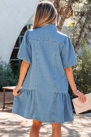 Denim dress with puff sleeves, ruffled hem, and button front, shown from the back.