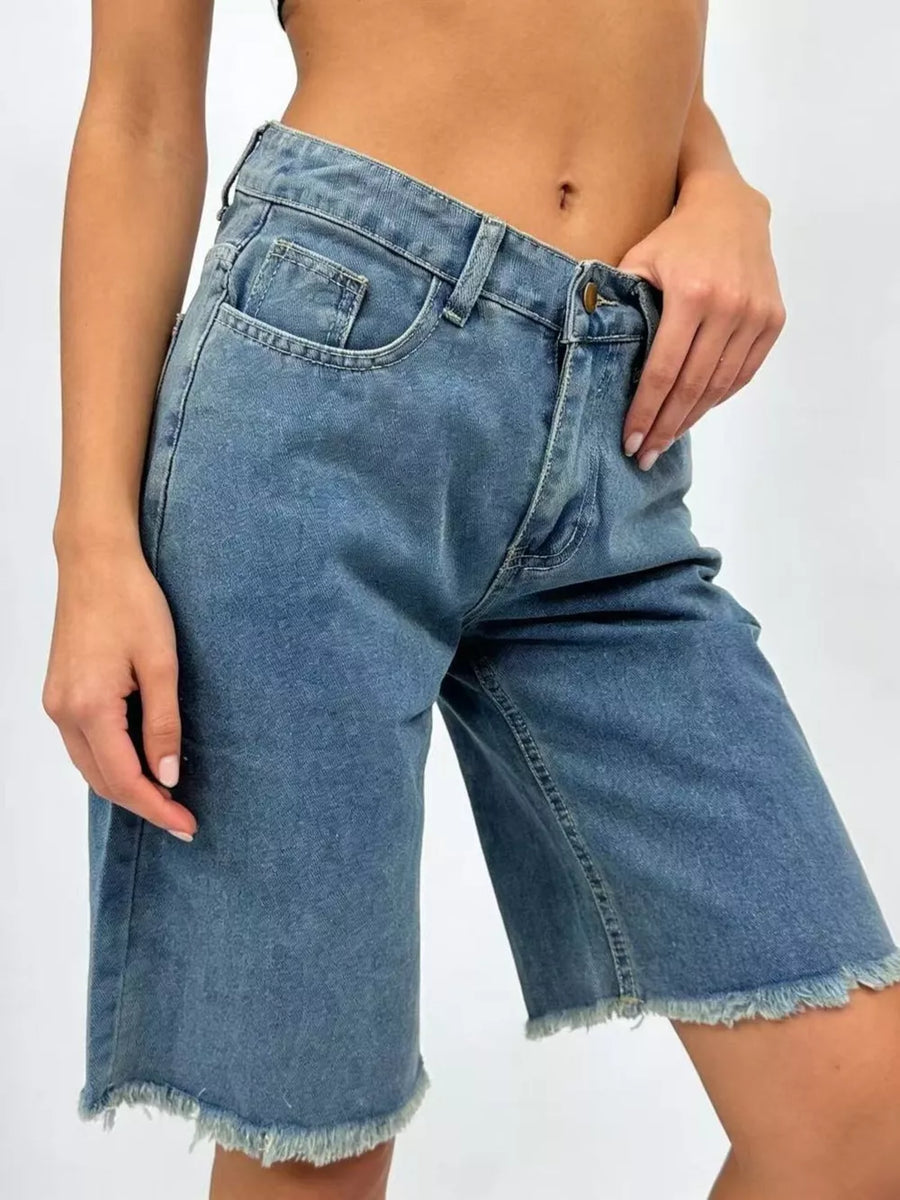 Blue denim bermuda shorts with frayed hem and relaxed fit.