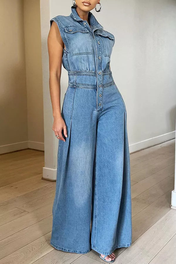 Denim jumpsuit with collared neckline, button-front, cinched waist, and wide legs.