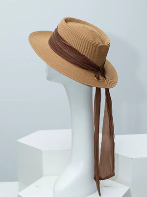 Brown straw sun hat with ribbon embellishment and long sheer ties