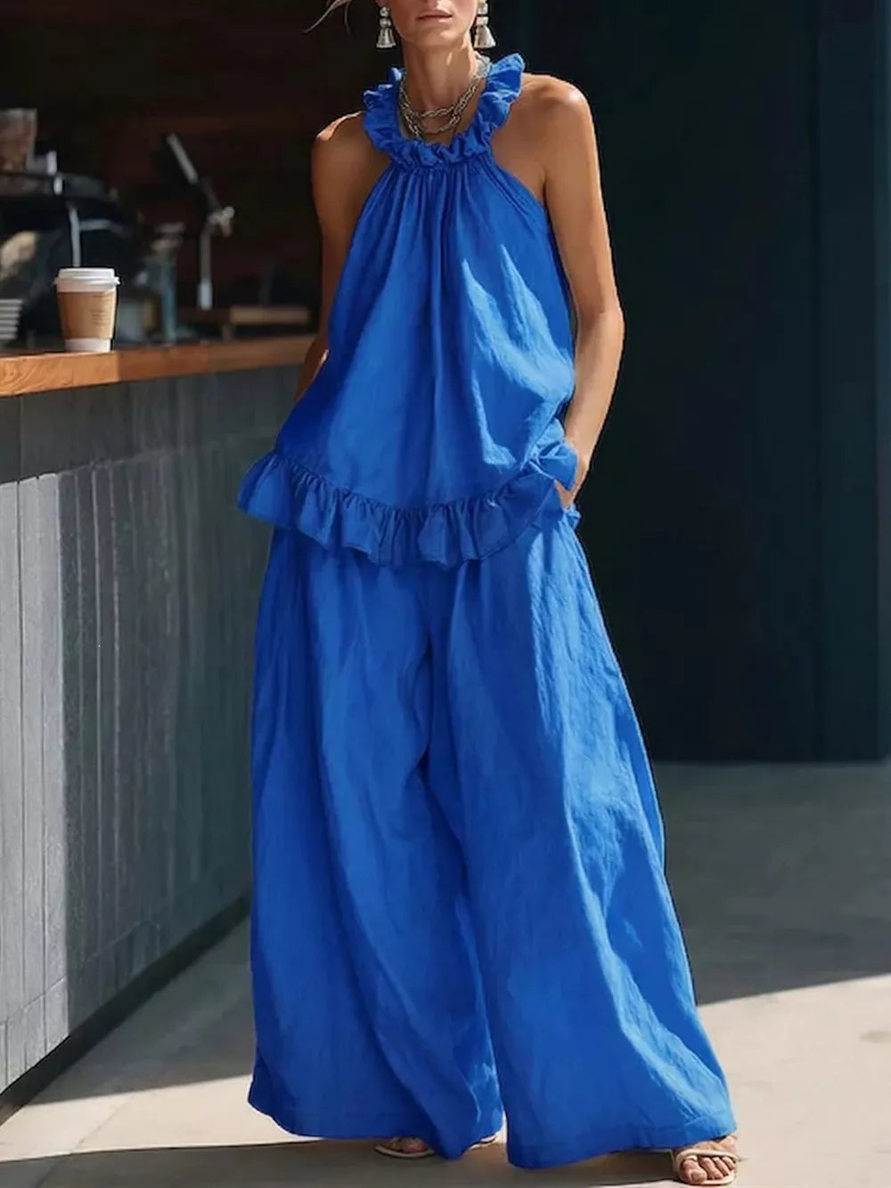 Blue ruffled halter neck top and wide-leg pants set with frill details.