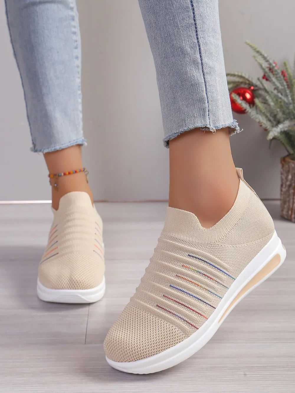 Striped knit slip-on wedge sneakers in light blue with colorful stripe detail.
