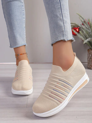 Striped knit slip-on wedge sneakers in light blue with colorful stripe detail.