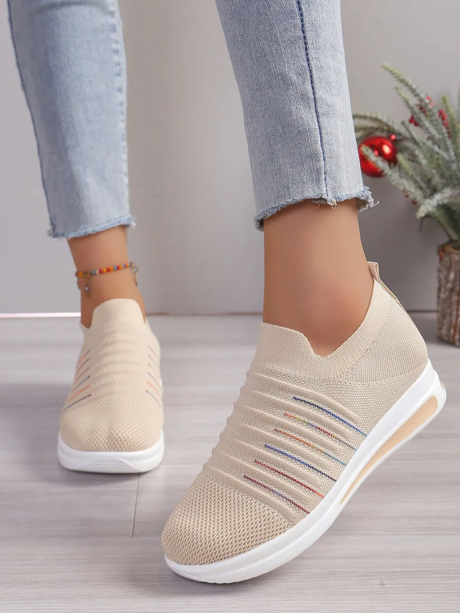 Striped knit slip-on wedge sneakers in light blue with colorful stripe detail.