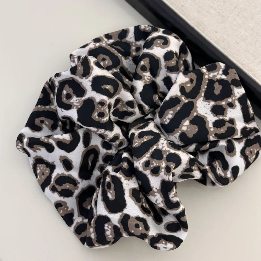 Leopard print silk scrunchie in tan and white.