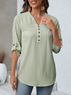 Green Bar striped V-neck blouse with button details and roll-up sleeves.