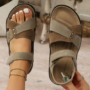 Two-toned brown open-toe platform sandals with adjustable straps and crisscross detail.