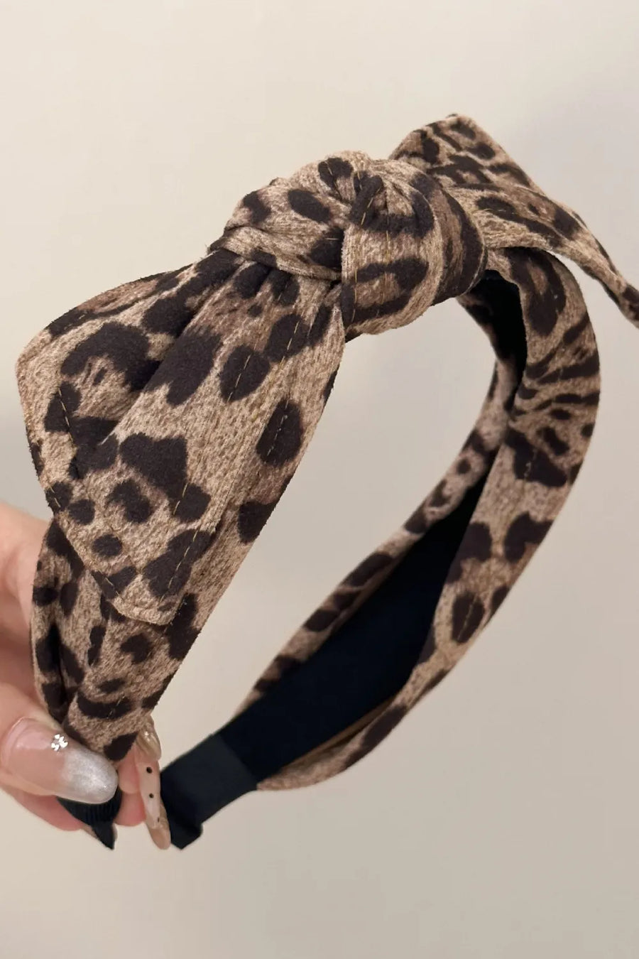 Leopard print knotted headband with a bold design.