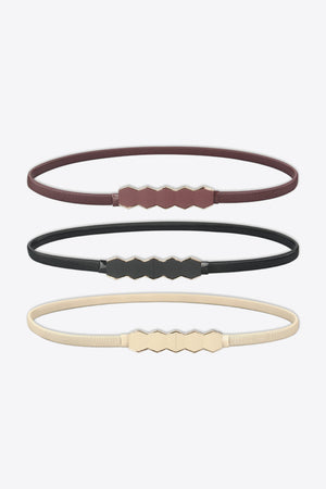 Thin elastic belts in black, cream, and wine with geometric buckle detail