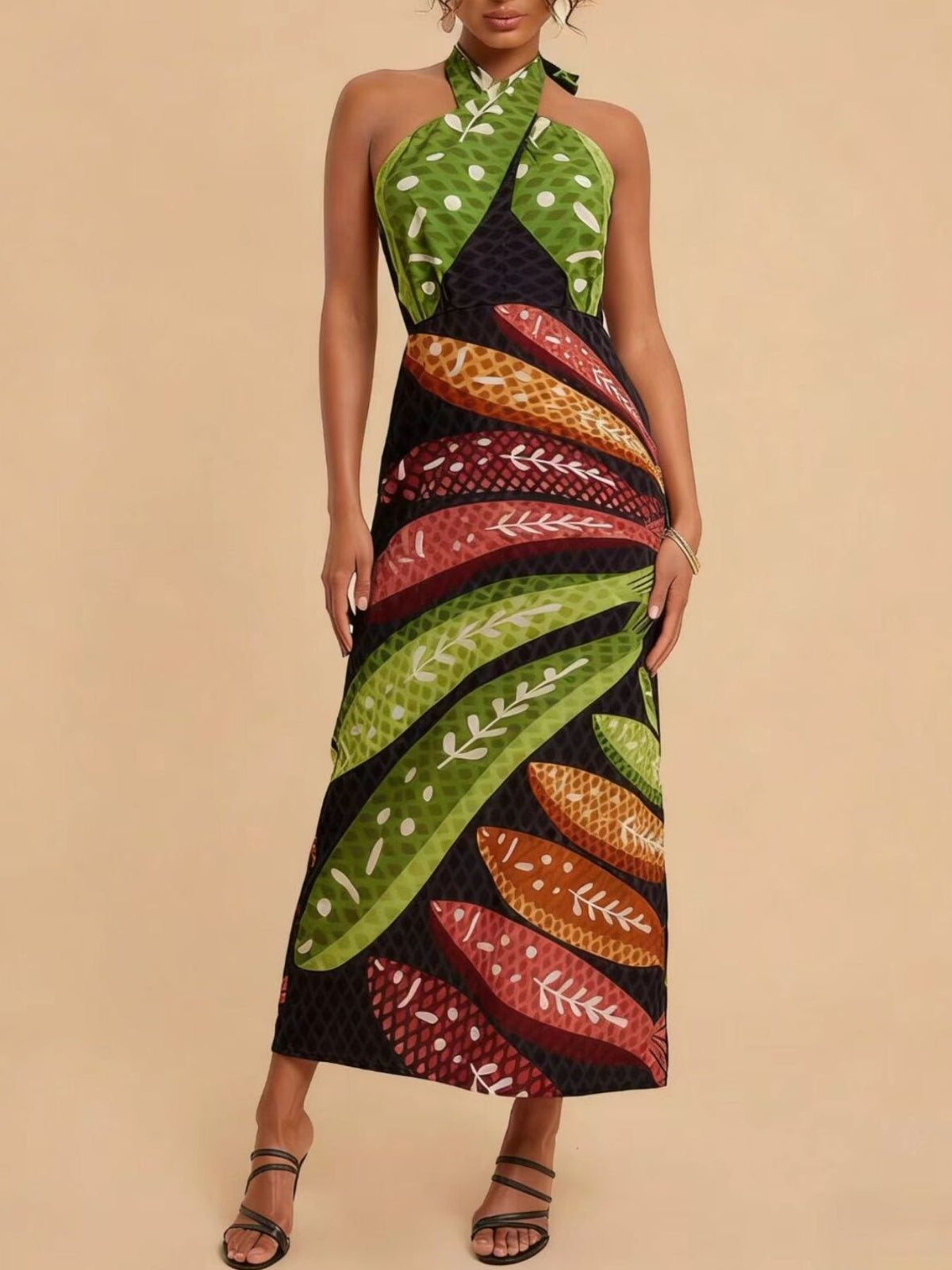 Tropical print halter neck midi dress with green, red, and orange leaf patterns.