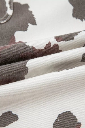 Cow print denim jeans with utility pockets, white with brown and grey abstract cow spots.