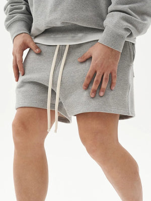 Light Gray fleece drawstring shorts with a relaxed fit and cream drawstrings.