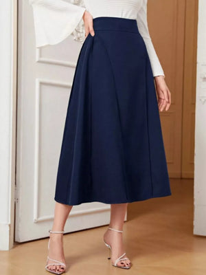 Navy high-waisted midi skirt with a flared A-line cut, shown with a white top and strappy heels.