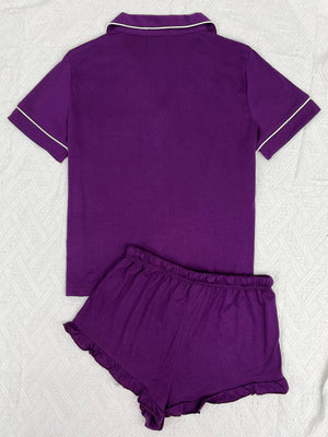 Purple pajama set with white trim and ruffled shorts