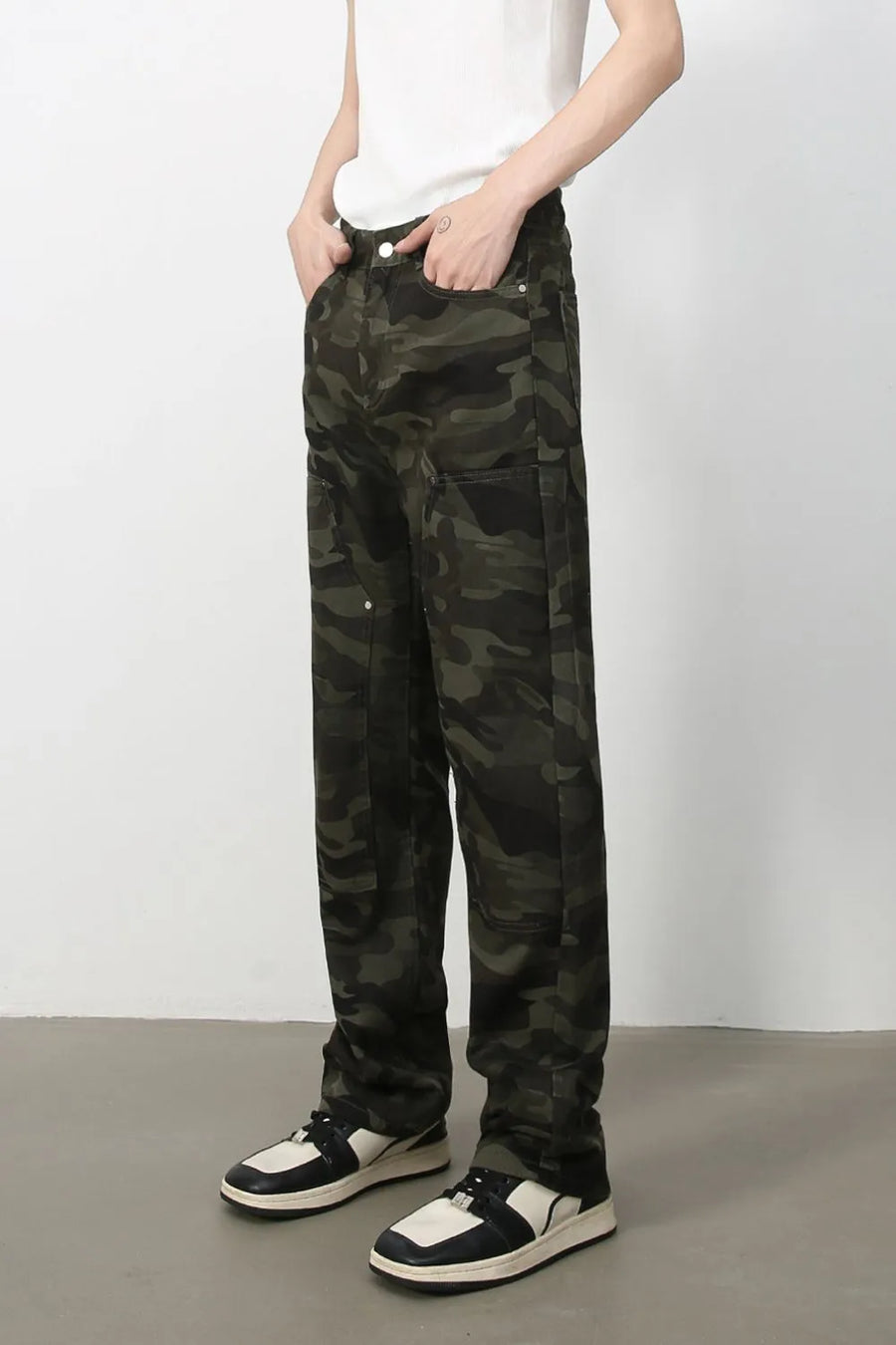 Utility camo carpenter jeans in black with multiple pockets and a relaxed fit.