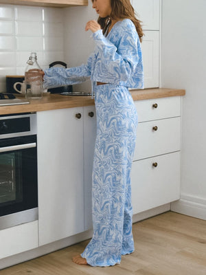 Blue and white marble print lounge set with drawstring pants and cropped long-sleeve top.