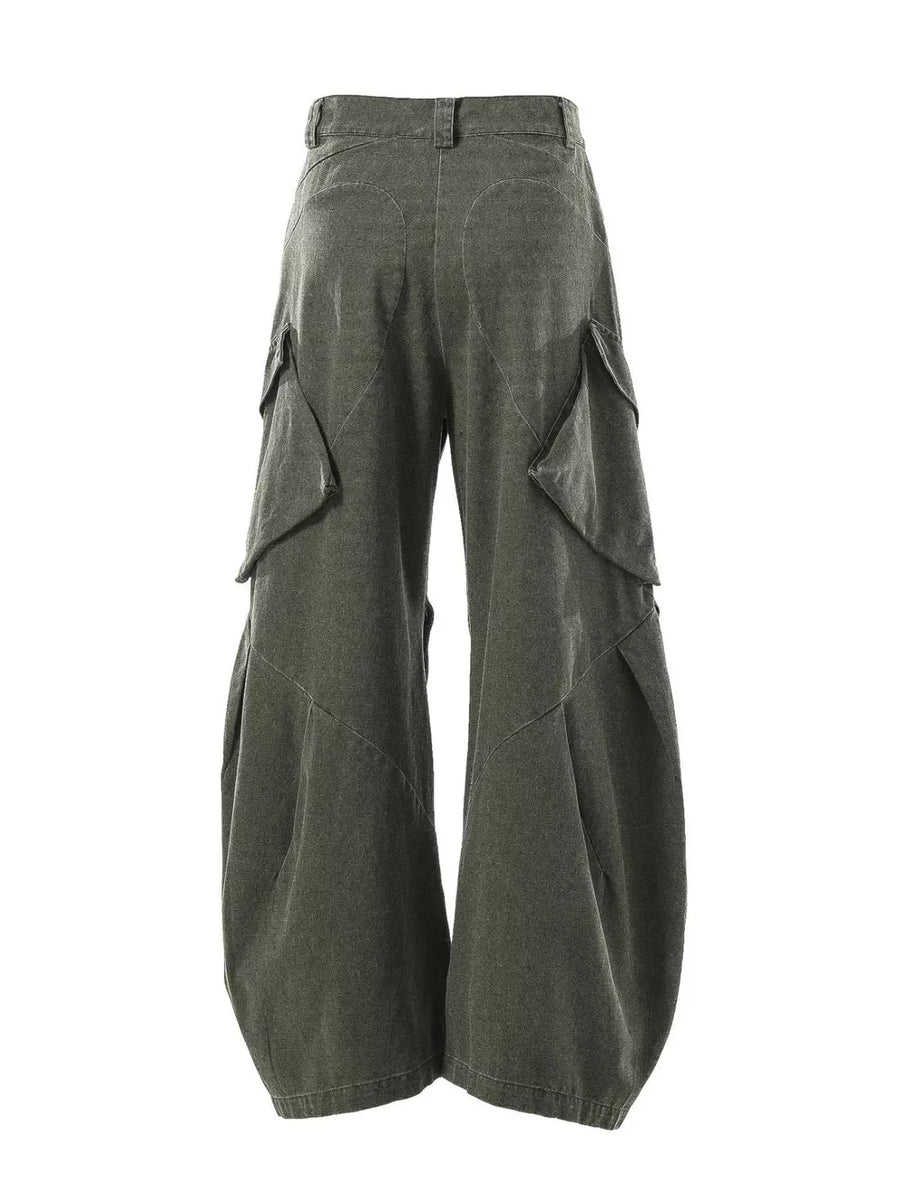 Textured paneled cargo pants in army green with baggy fit and multiple flap pockets.