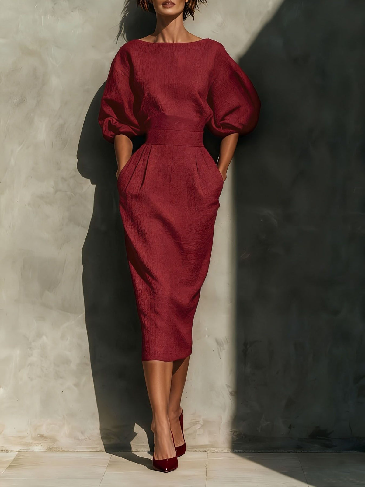 Wine red midi dress with puff sleeves, boat neck, and pockets.