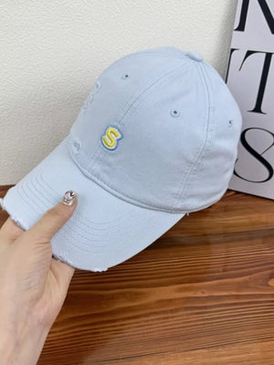 Light blue distressed baseball cap with yellow embroidered S logo
