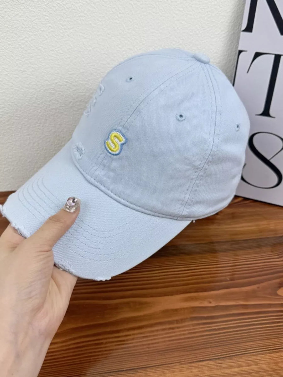 Light blue distressed baseball cap with yellow embroidered S logo