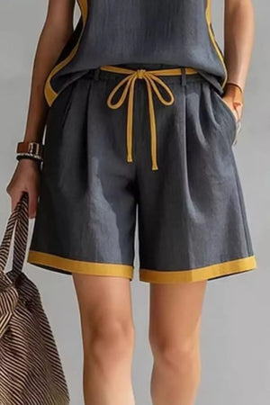 Dark gray shorts set with yellow contrast trim and drawstring waist, featuring a tank top and pleated shorts.